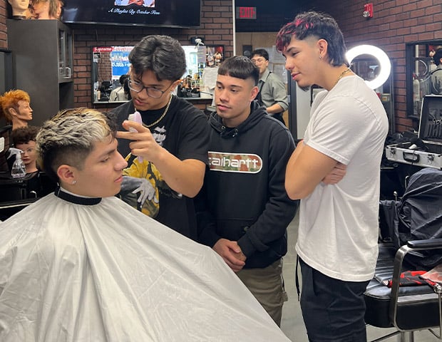Barber Professional Barber Professional Training- a group of men standing around a man's hair