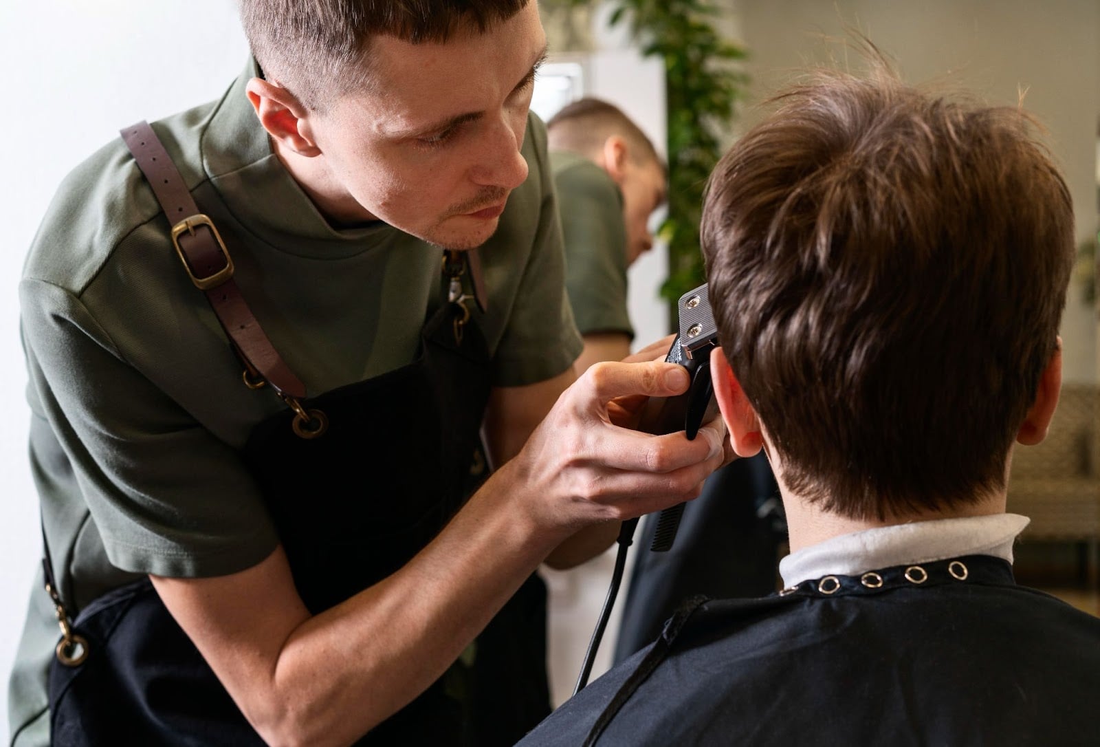 Student doing haircut at barber saloon