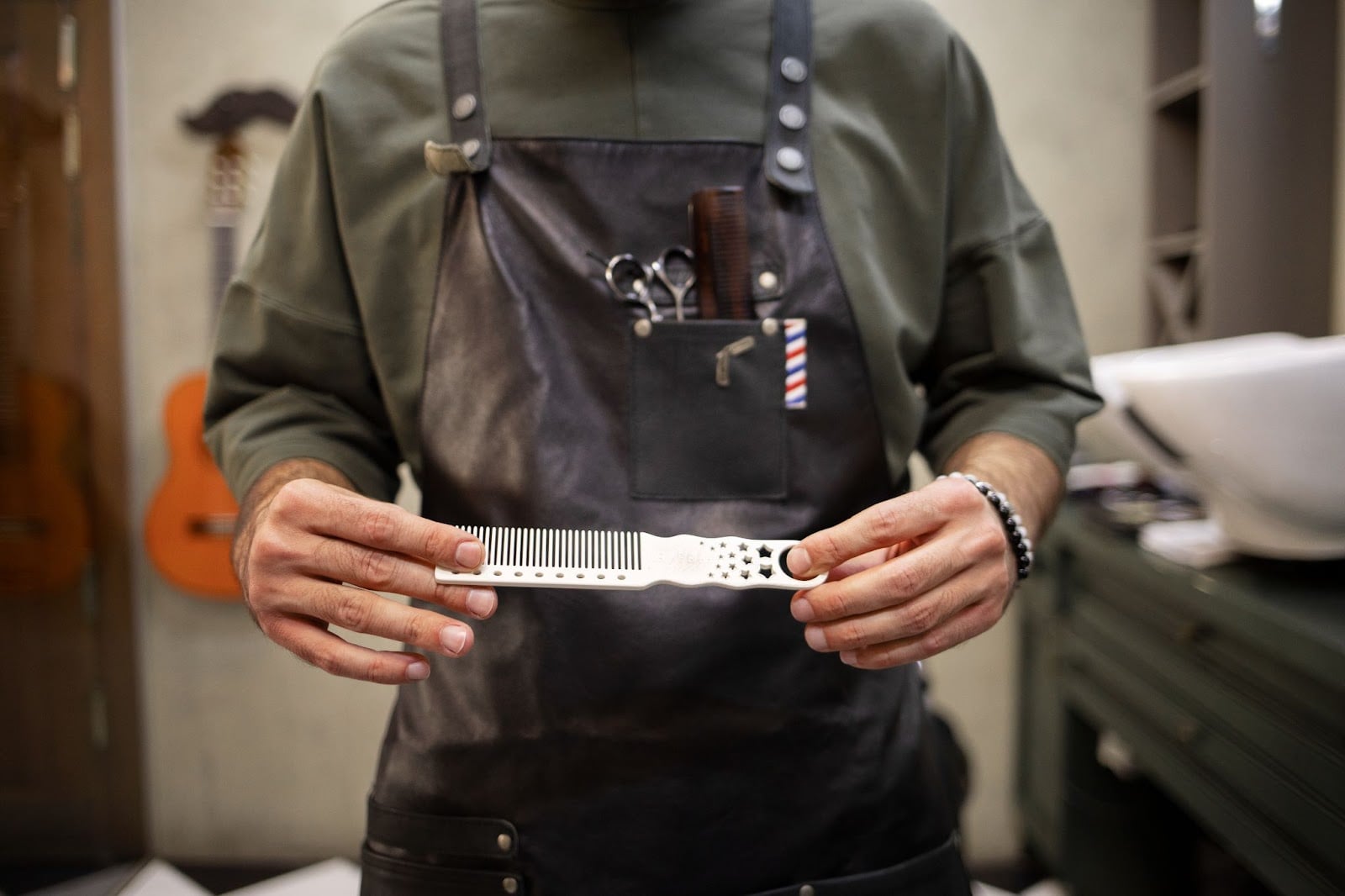 How Long Does It Take to Become a Barber in Illinois? 5 Barber student holding a tool in his hand