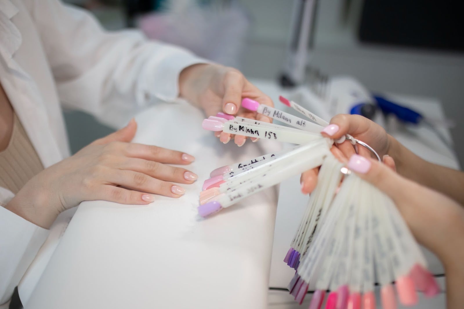 Person choosing between different nail colors