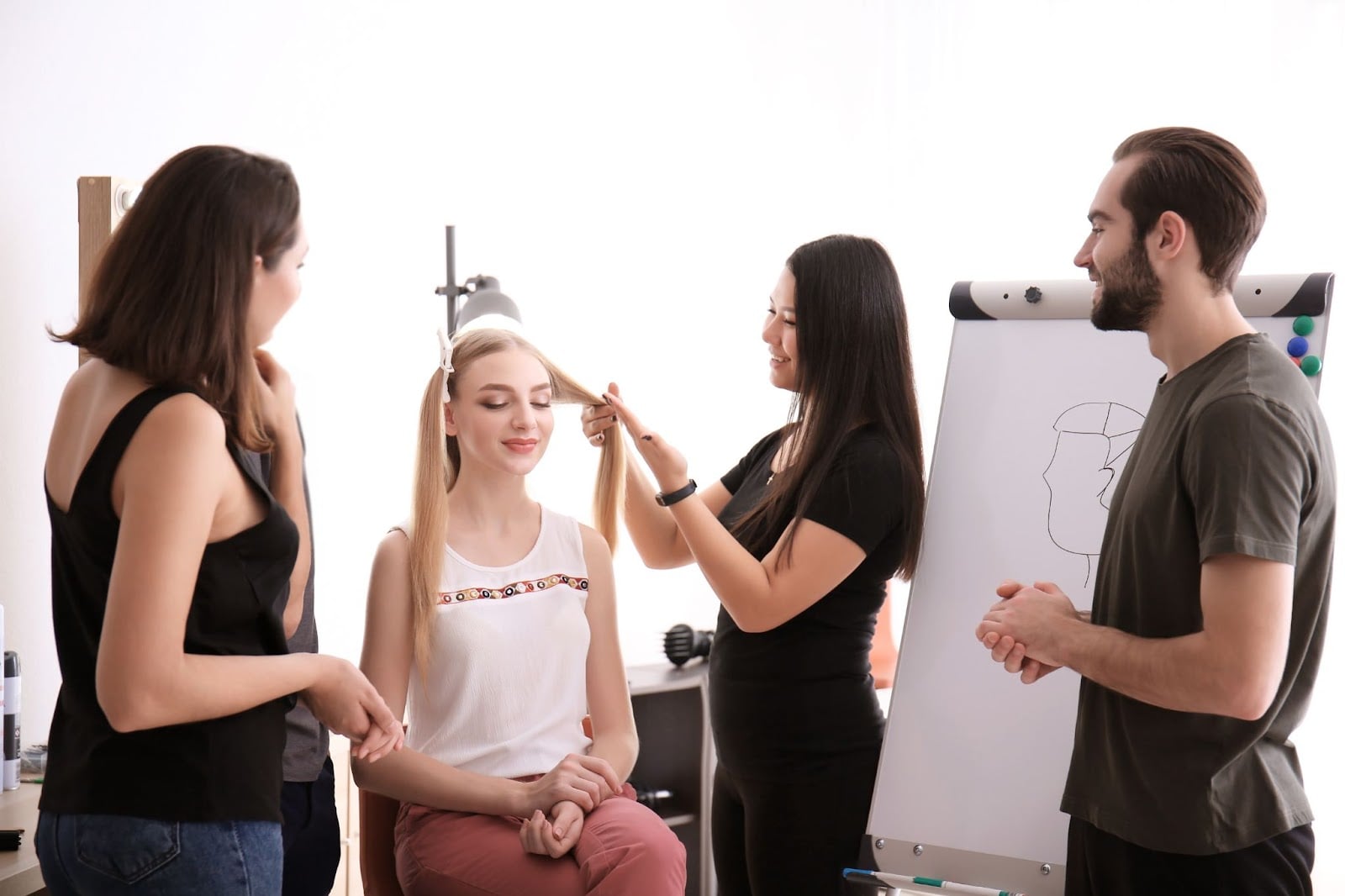 Cosmetology student practicing haircut technique on a girl
