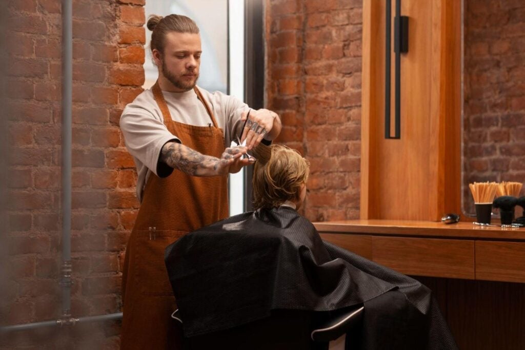 The Top Eight Personality Traits of Successful Hairstylists 3 Barber school student practicing hair styling for kids.