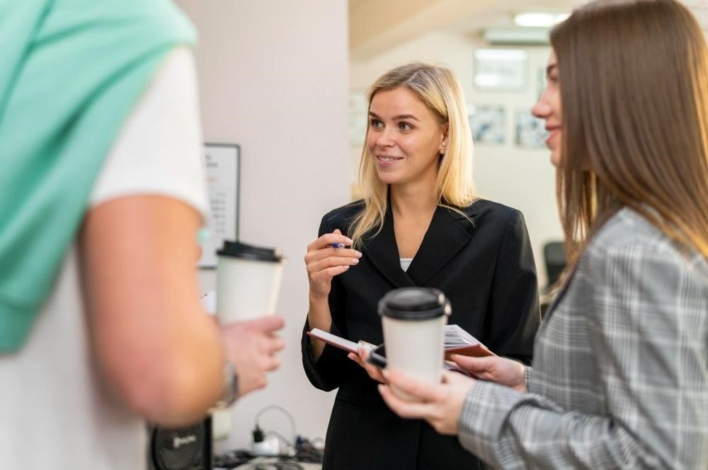 The Top Eight Personality Traits of Successful Hairstylists 4 Hairstylist talking to her clients during a consultation.