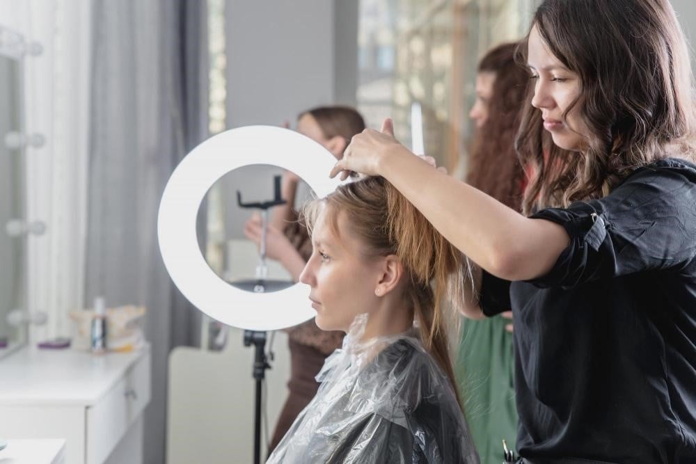 Students practicing hair cutting techniques at a cosmetology school in Illinois 