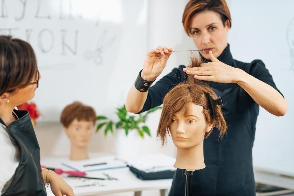 A hair cutting class at a beauty school in Illinois