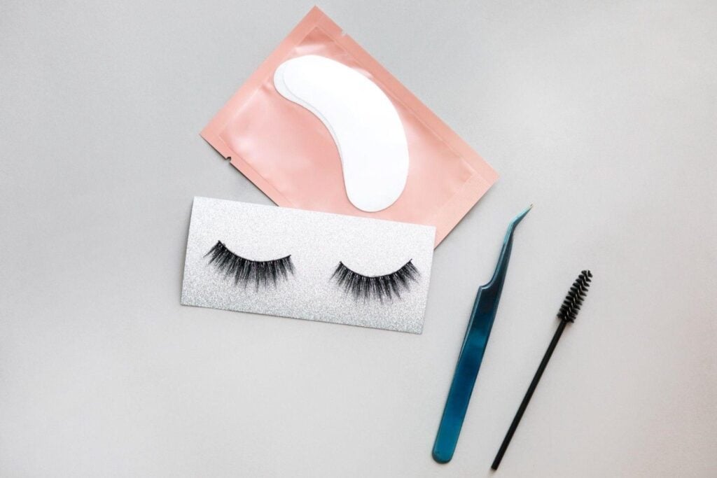 Lash Extension Types Every Cosmetologist Should Know 5 Lash extension tools: tweezers, adhesive, lash extensions, brushes.