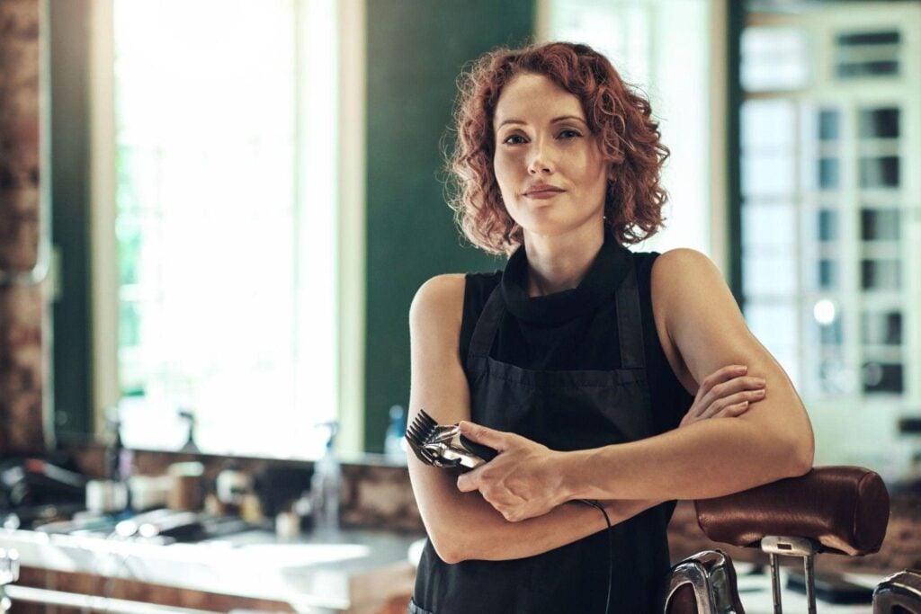 Best Beauty Jobs for Your Personality and Goals 6 Professional hairstylist posing at their hair salon