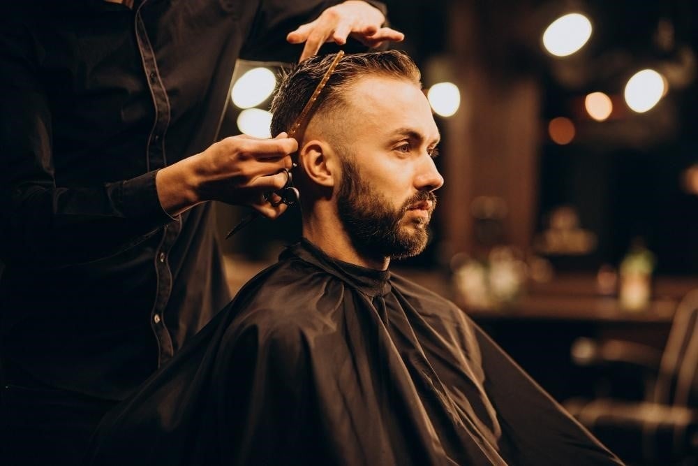Best Beauty Jobs for Your Personality and Goals 2 Student practicing fades at a barber school in Illinois