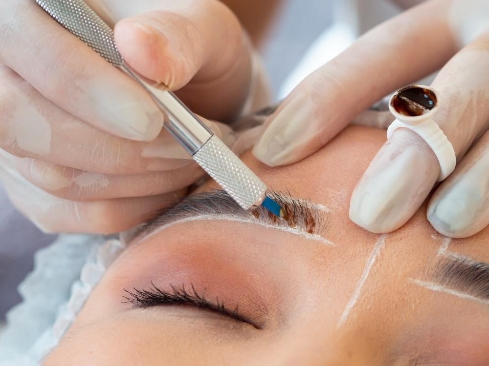 Best Beauty Jobs for Your Personality and Goals 4 Student practicing different brow shaping techniques at a brow tech school