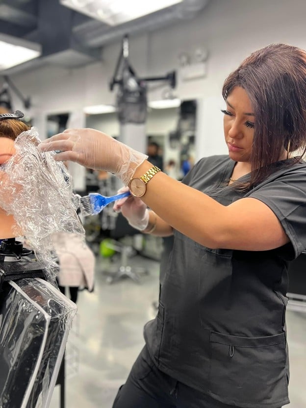 Top 3 Ways to Do Ombre Hair: A Guide for Aspiring Hairstylists 1 Cosmetology instructor demonstrating professional hair coloring and blending techniques to students at an Illinois beauty school