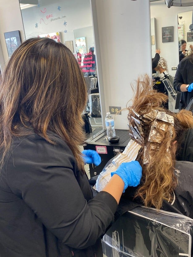 Top 3 Ways to Do Ombre Hair: A Guide for Aspiring Hairstylists 3 Cosmetology student practicing ombre hair coloring with foils during hands-on training at Cosmetology & Spa Academy in Illinois