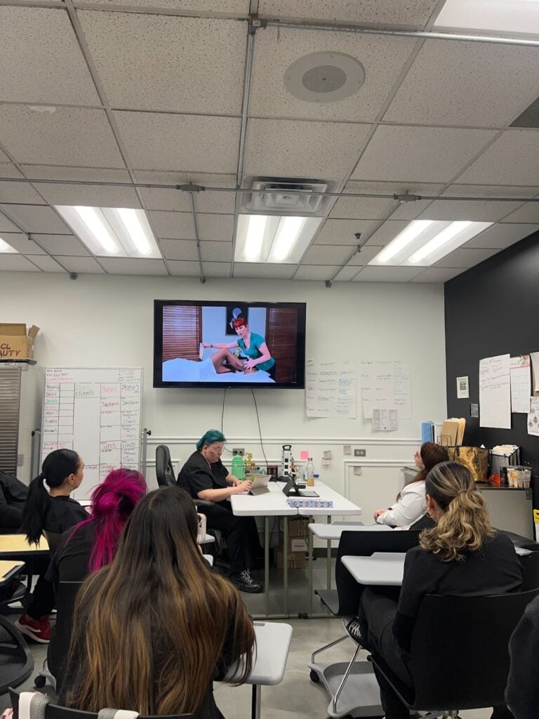 Advanced Facial Treatments Every Esthetician Should Master 4 Classroom with students watching a presentation.